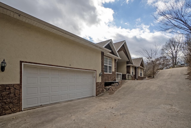 view of side of home featuring a garage