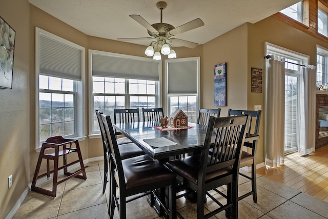 dining area featuring light tile patterned floors and ceiling fan