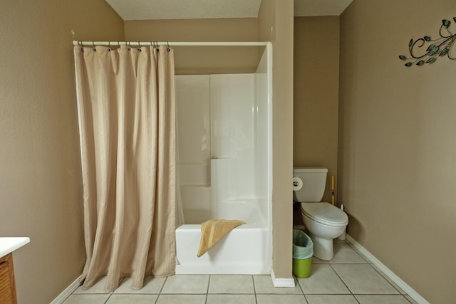 full bathroom with shower / bathtub combination with curtain, vanity, tile patterned floors, and toilet