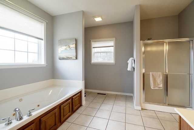 bathroom with independent shower and bath, tile patterned flooring, and a wealth of natural light