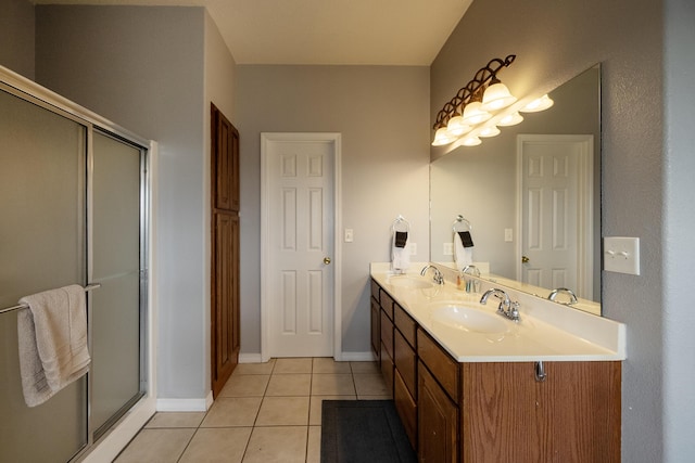 bathroom with tile patterned flooring, vanity, and walk in shower