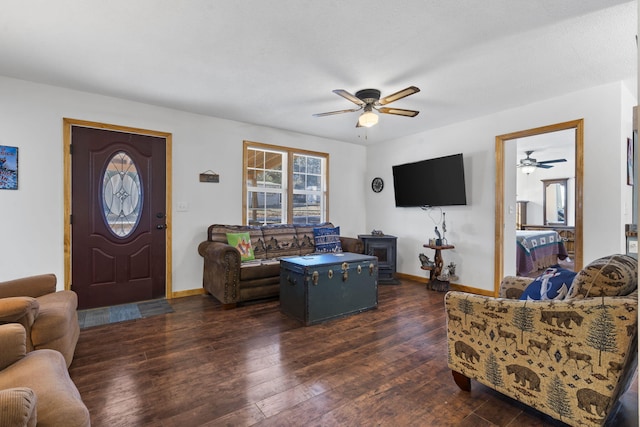 living room featuring dark hardwood / wood-style flooring and ceiling fan