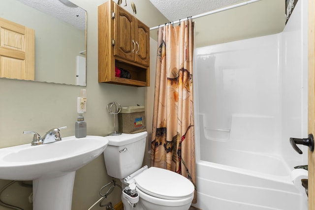 bathroom with shower / bathtub combination with curtain, toilet, and a textured ceiling