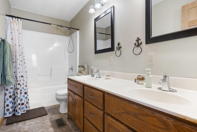 full bathroom with vanity, shower / bath combination with curtain, a textured ceiling, and toilet