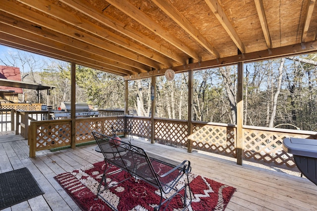 wooden deck featuring a grill