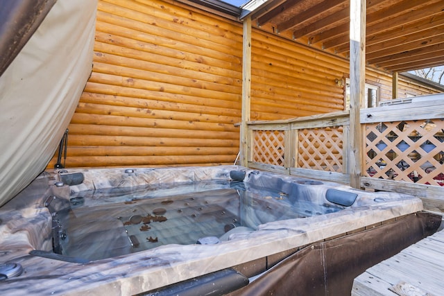 exterior details featuring a hot tub and a skylight