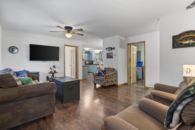 living room featuring dark hardwood / wood-style floors and ceiling fan