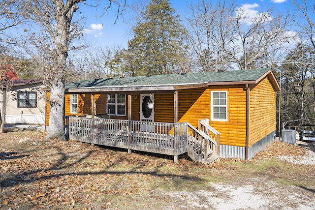 view of front of house with a porch and central AC