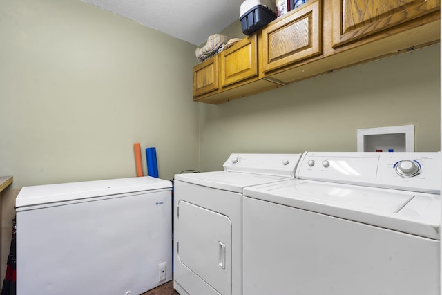 washroom with cabinets and independent washer and dryer