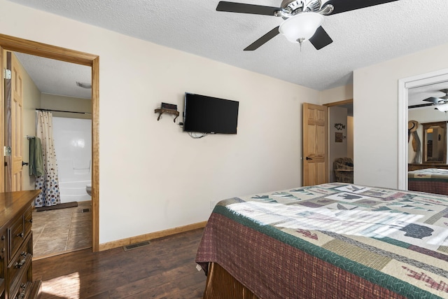 bedroom with ceiling fan, ensuite bath, dark hardwood / wood-style flooring, and a textured ceiling