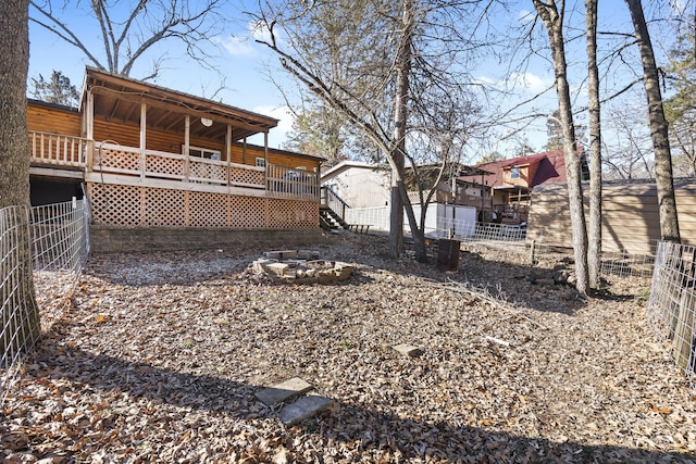 view of yard featuring a wooden deck and an outdoor fire pit