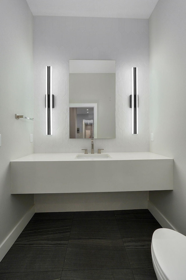 bathroom featuring vanity, decorative backsplash, and toilet