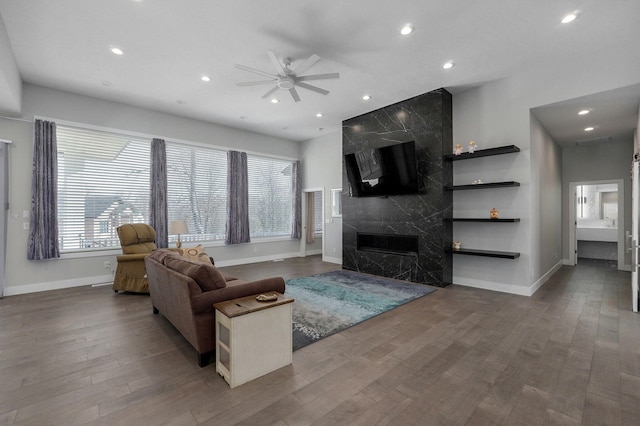 living room featuring hardwood / wood-style flooring, a fireplace, and ceiling fan