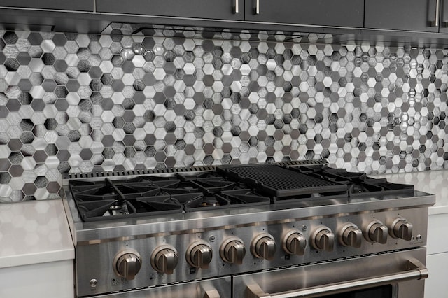 room details featuring tasteful backsplash and high end stove