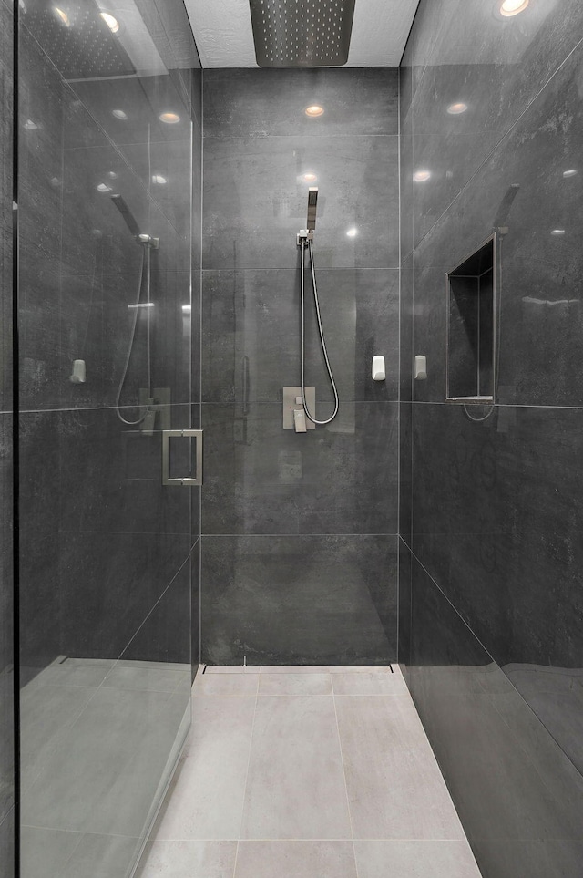 bathroom featuring a shower with door