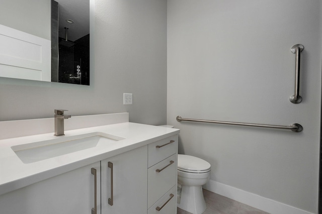 bathroom with vanity, tile patterned flooring, toilet, and walk in shower