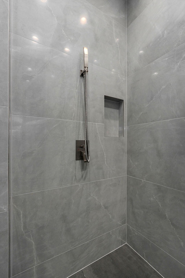 bathroom with a tile shower