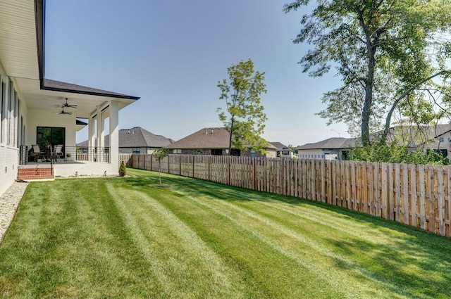 view of yard featuring a patio area and ceiling fan