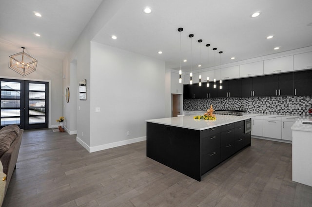 kitchen featuring hanging light fixtures, white cabinetry, hardwood / wood-style flooring, and a center island