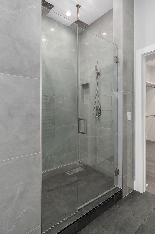 bathroom with a shower with door