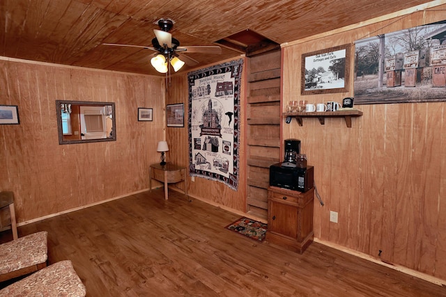 unfurnished room with dark hardwood / wood-style flooring, wood ceiling, ceiling fan, and wood walls