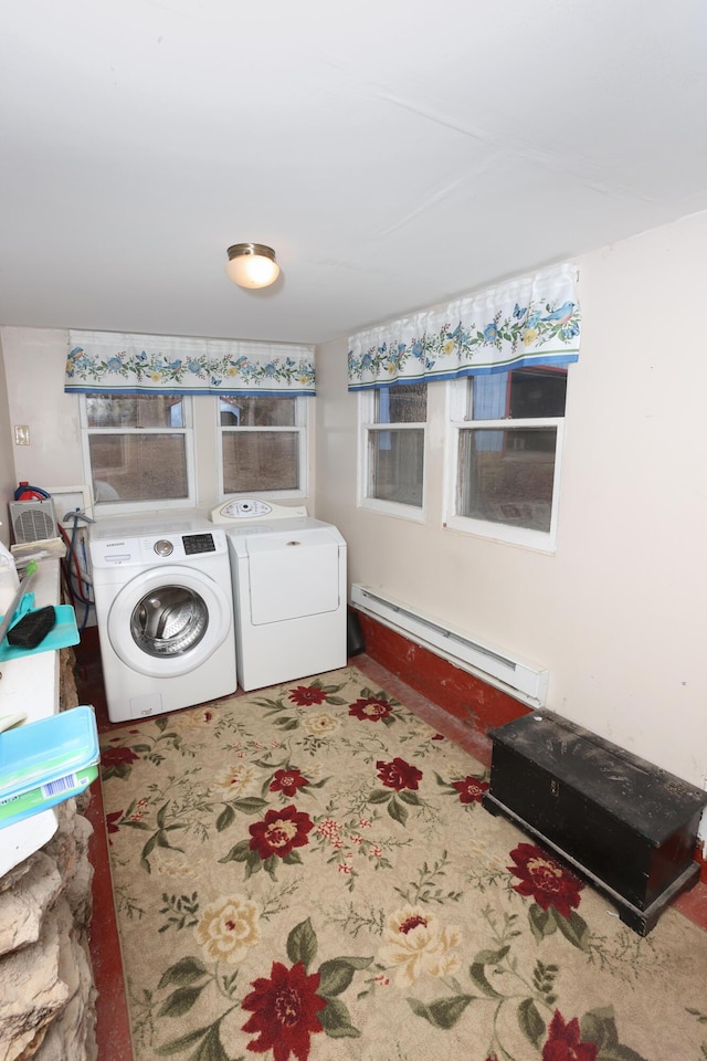 laundry area with a baseboard heating unit and independent washer and dryer