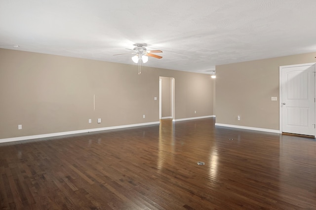 spare room featuring ceiling fan and dark hardwood / wood-style flooring