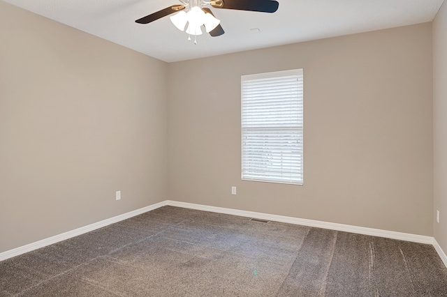 carpeted empty room with a wealth of natural light and ceiling fan