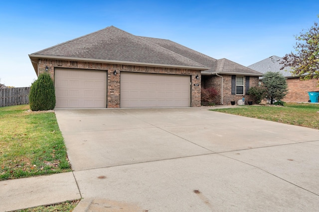 ranch-style house with a garage and a front yard