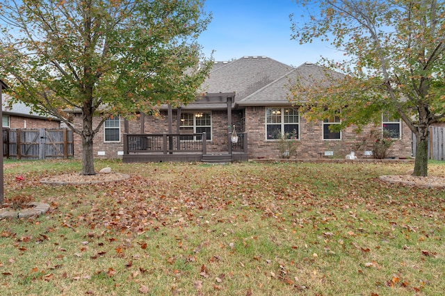 back of house featuring a deck and a lawn