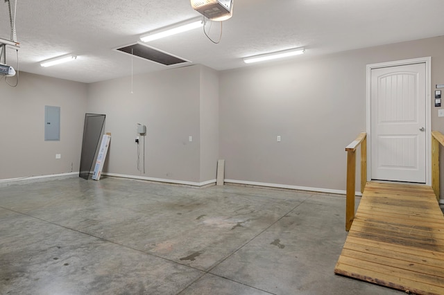 garage with a garage door opener and electric panel