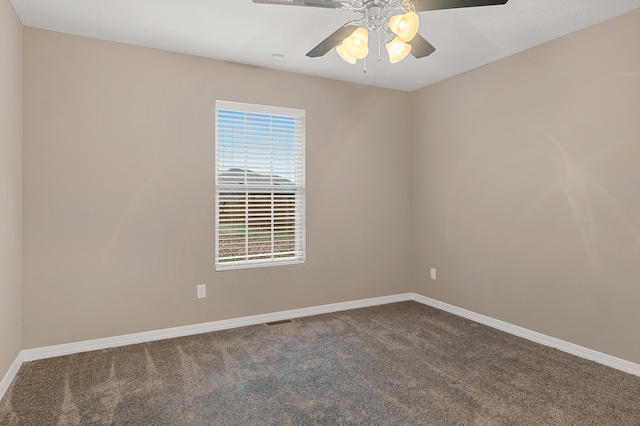 carpeted empty room featuring ceiling fan and plenty of natural light