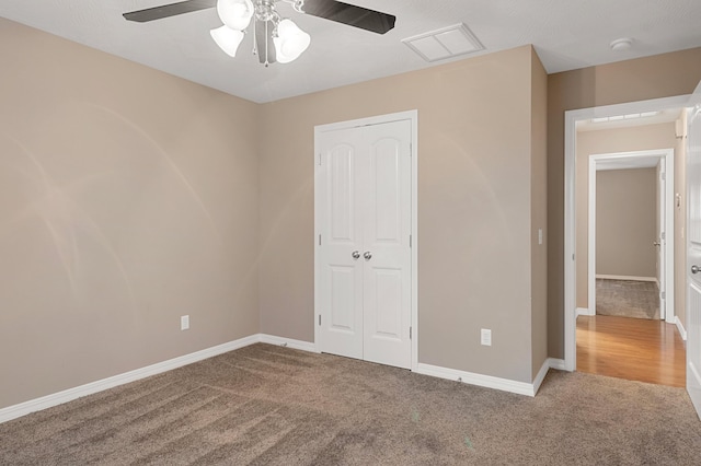 unfurnished bedroom with carpet, ceiling fan, and a closet