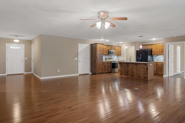 unfurnished living room with dark wood-type flooring and ceiling fan