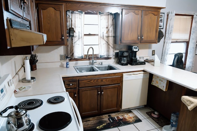 kitchen featuring sink, white appliances, ventilation hood, and light tile patterned flooring