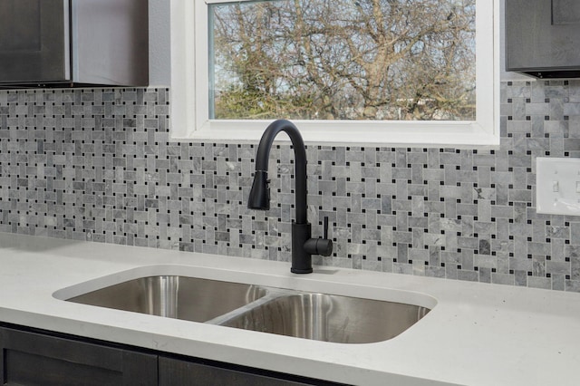 room details with a sink and decorative backsplash