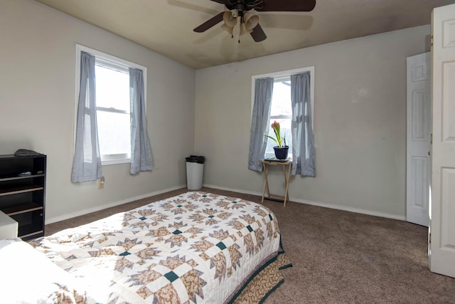 carpeted bedroom featuring multiple windows and ceiling fan