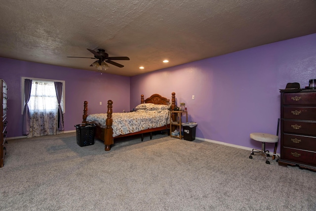 bedroom with a textured ceiling, ceiling fan, and carpet