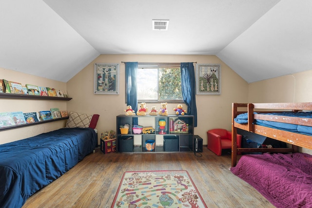 bedroom featuring vaulted ceiling and hardwood / wood-style floors