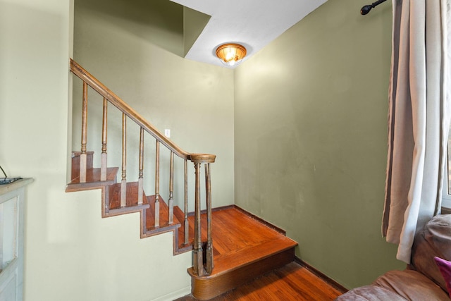 stairs with hardwood / wood-style floors