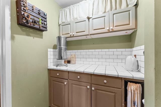 kitchen with decorative backsplash and tile counters