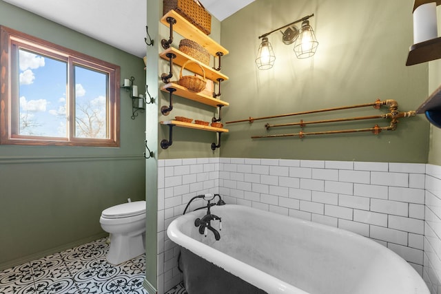 bathroom with tile patterned floors, toilet, and a bathing tub