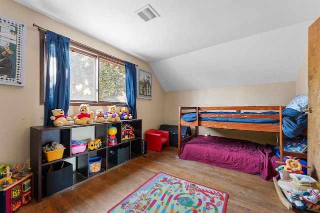 bedroom featuring lofted ceiling and hardwood / wood-style floors