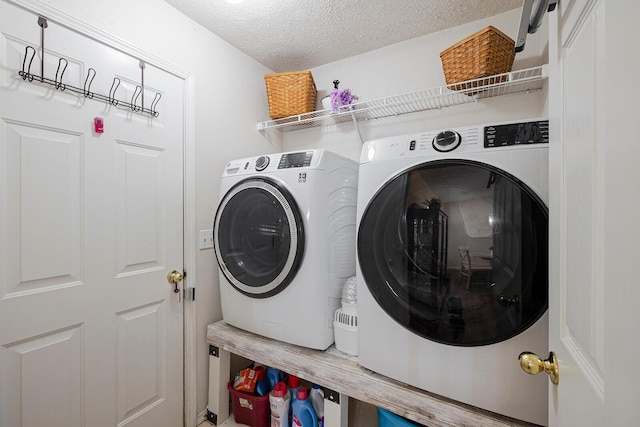 laundry area featuring independent washer and dryer and a textured ceiling