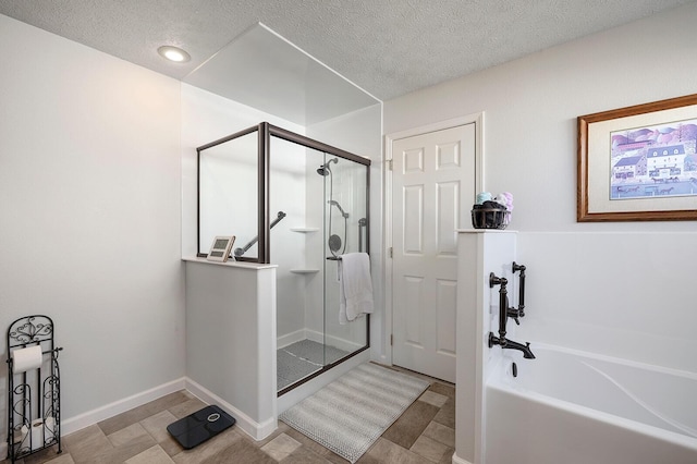 bathroom with shower with separate bathtub and a textured ceiling