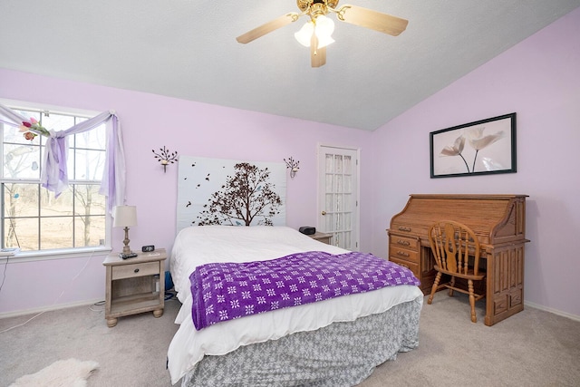 carpeted bedroom featuring vaulted ceiling and ceiling fan