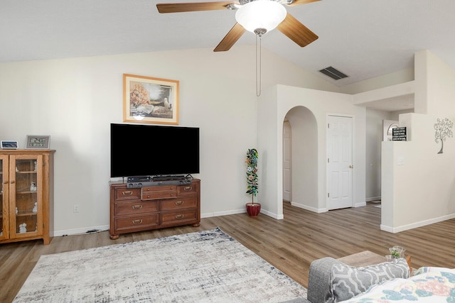 living room with hardwood / wood-style flooring, vaulted ceiling, and ceiling fan