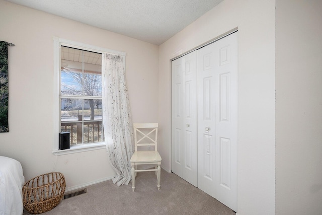 unfurnished room featuring light carpet and a textured ceiling