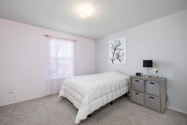 carpeted bedroom with a textured ceiling