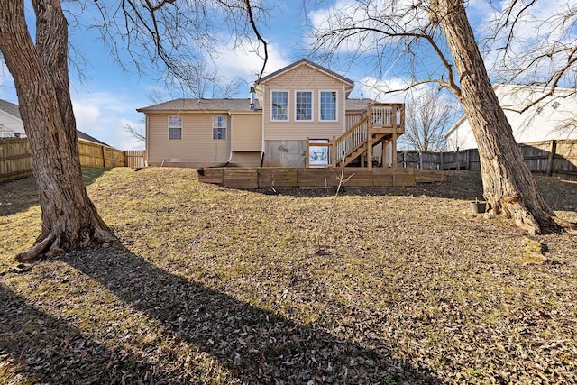 back of house with a wooden deck